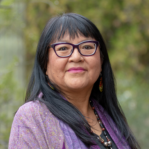 woman with long black hair in purple shirt