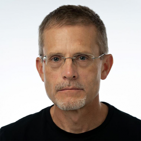 man with glasses in black shirt