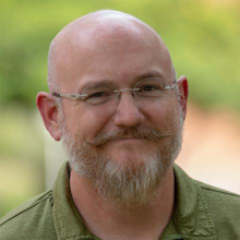 man in glasses with green shirt